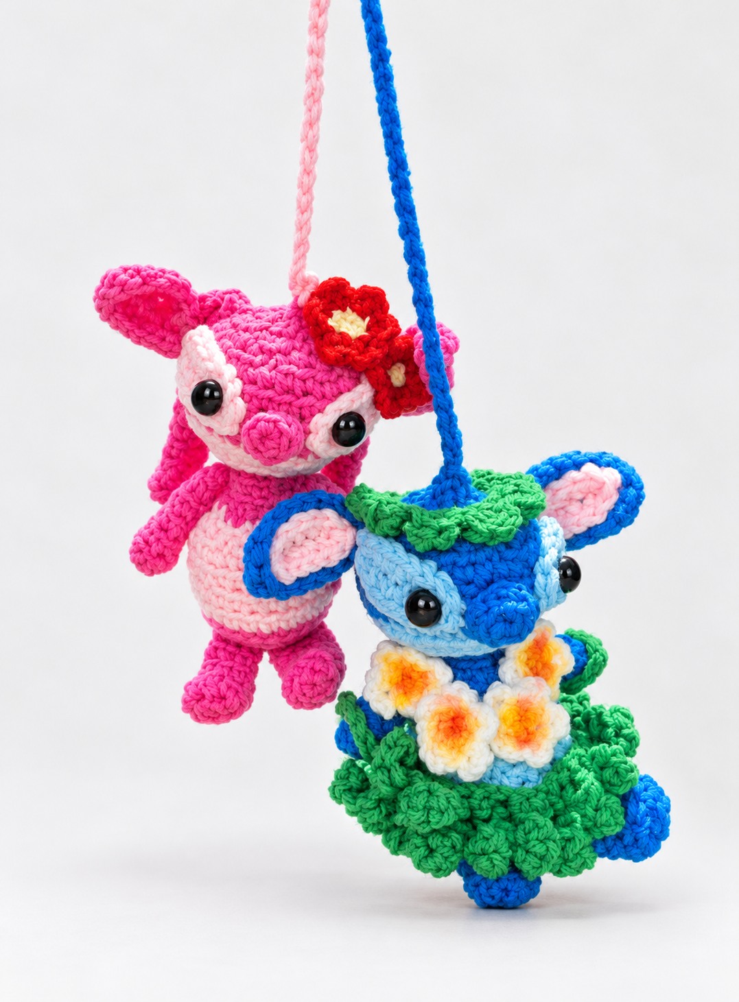 Pink and blue crochet character car mirror hanger pair
