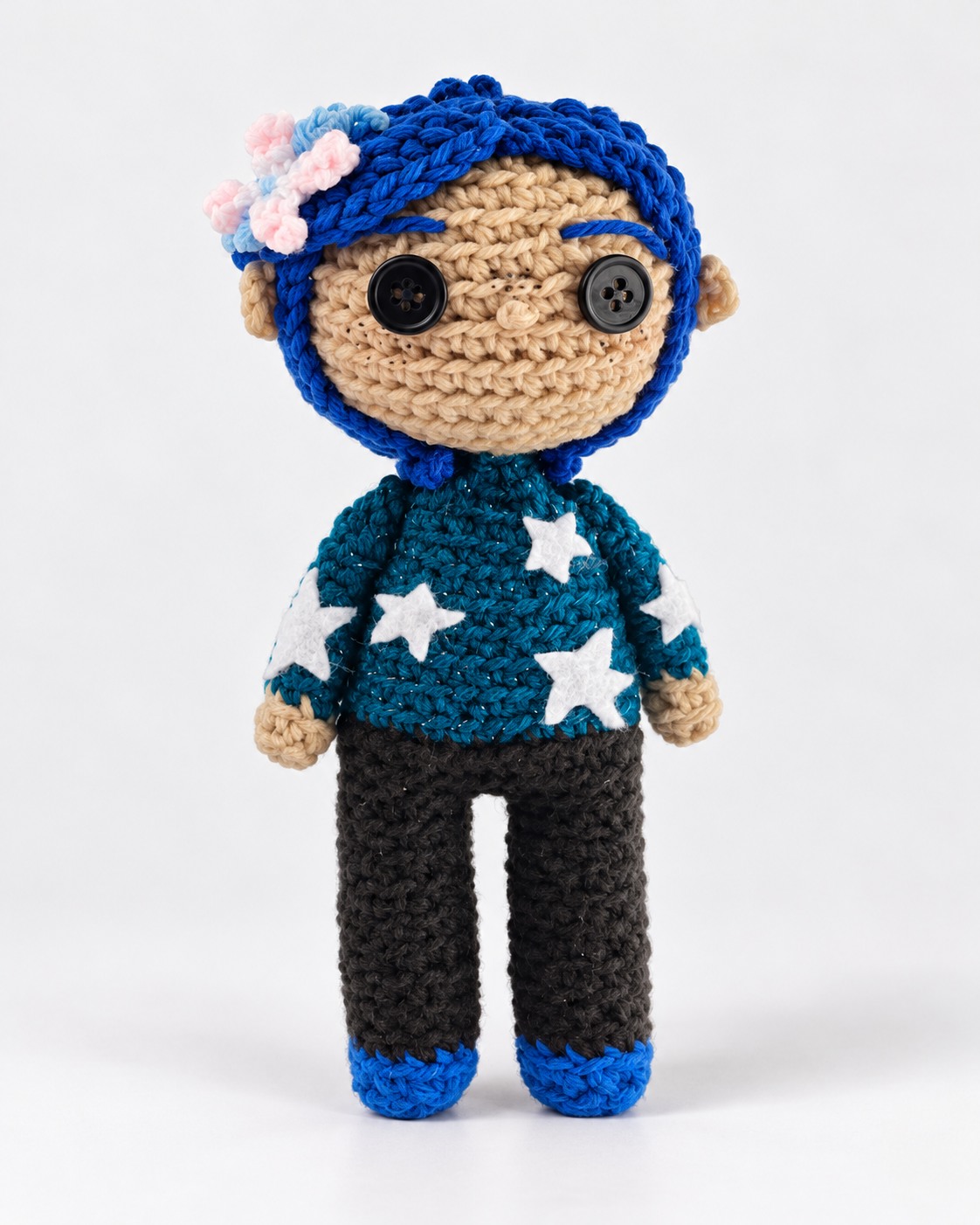 Blue-haired crochet character plushie wearing a star sweater