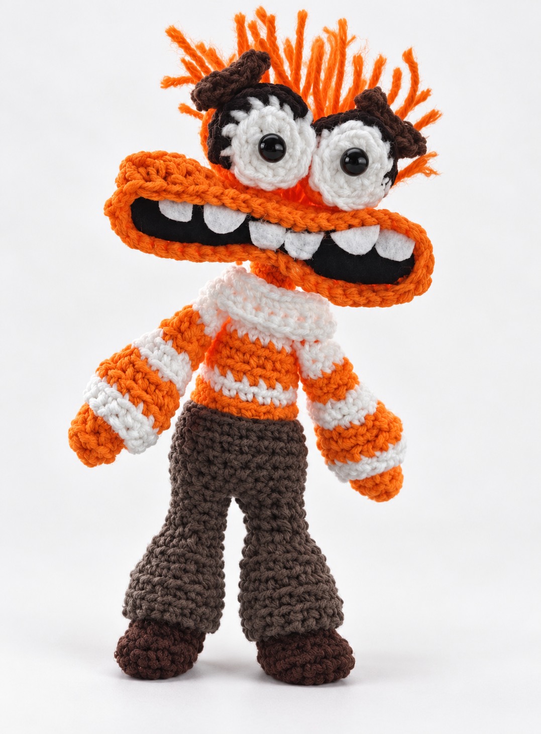Orange monster crochet character plushie with a wide toothy smile