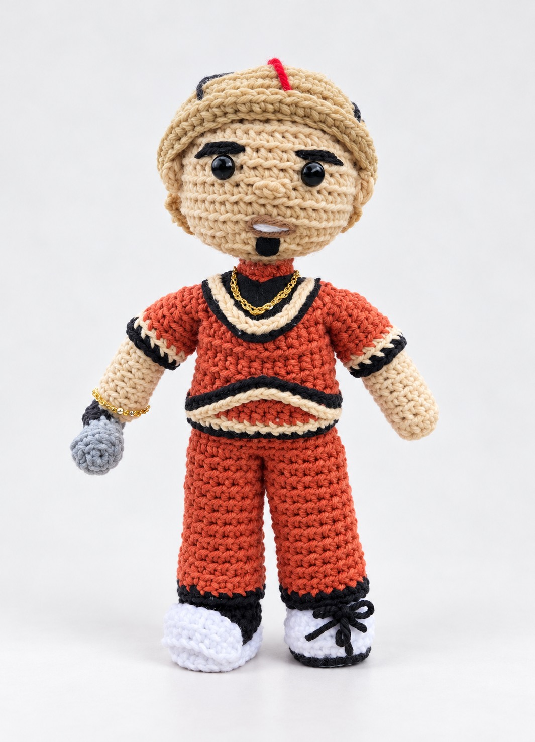 Crochet character plushie in a rust orange outfit
