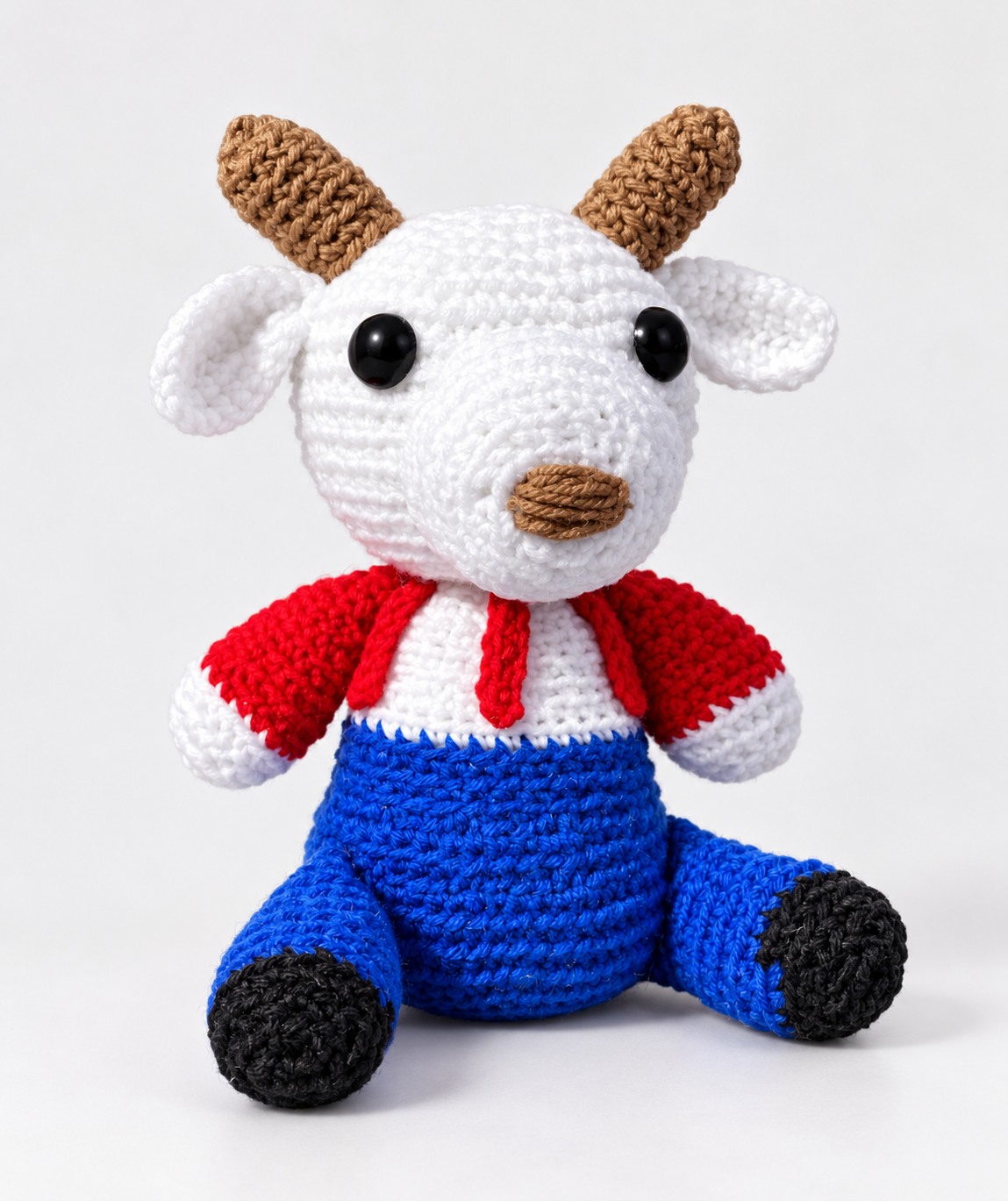 White reindeer crochet character plushie in red and blue