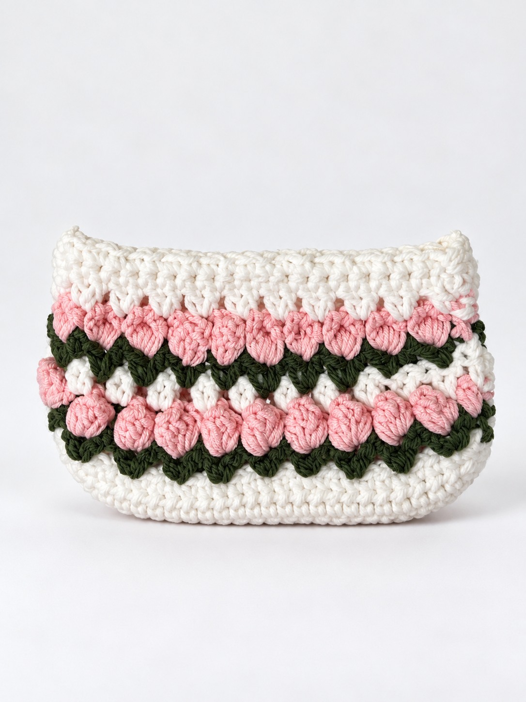 White crochet handbag with rows of pink tulips and green leaves