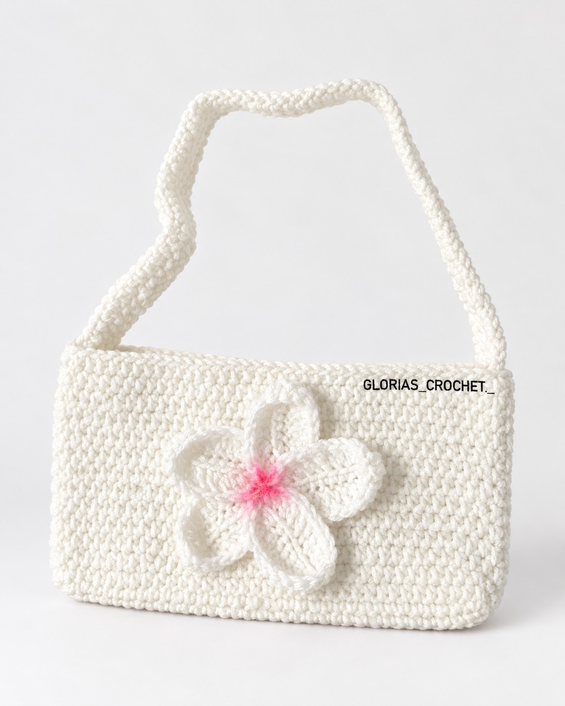 Small white crochet shoulder bag with a white flower and pink center